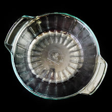 Load image into Gallery viewer, This large vintage clear glass lidded casserole dish has a distinctive scalloped design that makes cooking and serving effortless. It is oven, microwave, and dishwasher safe, making it easy to transport and reheat your favorite dishes with minimal mess. Crafted by Anchor Hocking, USA, circa 1950s, this dish is sure to bring style and convenience to your kitchen. In excellent condition, free from chips. Measures 9 inches / 23 cm Capacity 2 quarts/litres