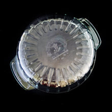Load image into Gallery viewer, This large vintage clear glass lidded casserole dish has a distinctive scalloped design that makes cooking and serving effortless. It is oven, microwave, and dishwasher safe, making it easy to transport and reheat your favorite dishes with minimal mess. Crafted by Anchor Hocking, USA, circa 1950s, this dish is sure to bring style and convenience to your kitchen. In excellent condition, free from chips. Measures 9 inches / 23 cm Capacity 2 quarts/litres