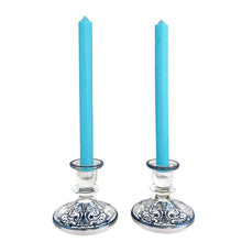 Load image into Gallery viewer, Stunning pair of vintage clear glass single lite candle holders featuring a silver overlay pattern with urn and floral scrolls. Silver City, 1950s. A romantic addition to your tablescape!
In vintage condition, the silver overlay is intact. There is a smooth chip to one piece, see photos.
Measures 4 1/4 x 4 1/4 x 3 3/4 inches