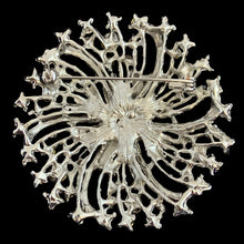 Load image into Gallery viewer, Reverse of vintage clear rhinestone starburst brooch showing silver-tone openwork back and pin clasp