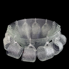 Load image into Gallery viewer, Vintage clear Soreno pressed glass punch bowl and 12 matching cups featuring a textured bark surface. Crafted by Anchor Hocking, USA, 1966 - 1970. Perfect for serving your favourite concocted beverages.
All in excellent condition, no chips.
Bowl measures 12 3/4 x 6 inches
Cups measure 3 x 2 5/8 inches