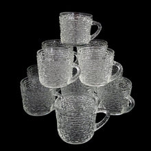 Load image into Gallery viewer, Vintage clear Soreno pressed glass punch bowl and 12 matching cups featuring a textured bark surface. Crafted by Anchor Hocking, USA, 1966 - 1970. Perfect for serving your favourite concocted beverages.
All in excellent condition, no chips.
Bowl measures 12 3/4 x 6 inches
Cups measure 3 x 2 5/8 inches