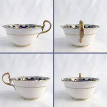 Load image into Gallery viewer, Antique bone china teacup and saucer is absolutely stunning! Both have a subtle scalloped shape. The white cup is decorated in a design of pale blue floral bouquets and bows on a cobalt blue band with gold gilt details. Produced by Aynsley, England. Excellent condition, free from chips, cracks and repairs. The pattern number 3410 is painted on the saucer. The stamped maker's mark indicates production between 1905 - 1925. Teacup measures 3 1/2 x 2 1/4 inches | Saucer measures 5 5/8 inches