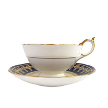 Load image into Gallery viewer, Vintage Bone China teacup and saucer with scalloped edge features a hand painted cobalt blue and pale yellow banded interior on a white ground, lavishly decorated with gold gilt filigree, complemented by pink cabbage roses at the bottom of the cup and centre of the saucer. Aynsley, England. 1930s. In excellent condition. Maker's mark with decorator's hand painted C553 Teacup measures 4 x 2 1/4 inches Saucer measures 5 5/8 inches