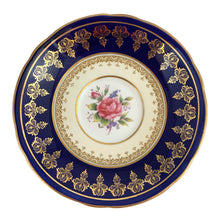 Load image into Gallery viewer, Vintage Bone China teacup and saucer with scalloped edge features a hand painted cobalt blue and pale yellow banded interior on a white ground, lavishly decorated with gold gilt filigree, complemented by pink cabbage roses at the bottom of the cup and centre of the saucer. Aynsley, England. 1930s. In excellent condition. Maker's mark with decorator's hand painted C553 Teacup measures 4 x 2 1/4 inches Saucer measures 5 5/8 inches