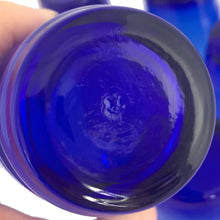Load image into Gallery viewer, Bottom of a single Cameron glass tumbler, showing the smooth cobalt blue base and Anchor Hocking maker's mark