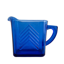Load image into Gallery viewer, Classic vintage cobalt blue Chevron pressed glass creamer. Crafted by Hazel-Atlas Glass, USA, 1930s. Made in two sizes, this is the larger version. A stunning example of art deco tableware!
In excellent condition, no chips.
Measures 5 7/8 x 2 1/2 x 4 1/4 inches
Capacity 14 ounces