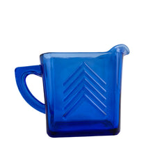 Load image into Gallery viewer, Classic vintage cobalt blue Chevron pressed glass creamer. Crafted by Hazel-Atlas Glass, USA, 1930s. Made in two sizes, this is the larger version. A stunning example of art deco tableware!
In excellent condition, no chips.
Measures 5 7/8 x 2 1/2 x 4 1/4 inches
Capacity 14 ounces