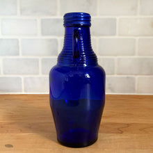 Load image into Gallery viewer, Opposite side profile of vintage cobalt blue Luna Café glass bottle showing full height, Madera Glass Co. 1998