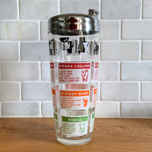 Load image into Gallery viewer, Mid-century vintage glass cocktail shaker with 12 drink recipes, colourful red, orange, green, topped with a border of black and white bar glass graphics and chrome lid. Produced by the Continental Can Company in the USA. A home bartender's dream...no Googling required! In excellent condition, free from chips/cracks, vibrant colours. Measures 4 x 9 inches