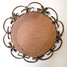 Load image into Gallery viewer, Bring on the mid-century vintage vibes with this round convex mirror encased in copper toned metal featuring a pierced metal band, surrounded with scrolled metal sections and impressed metal flowers. The mirror has a wood backing and a built in wall hanger. Circa 1950s. This beauty is ready to hang and is sure to add a special touch of glam to your bath, bedroom or entranceway! In excellent condition. Measures 17 1/2 inches in diameter