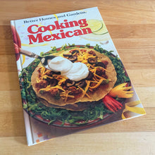 Load image into Gallery viewer, Better Homes and Gardens is known for its fabulous cookbooks. This hardcover cookbook focuses on Cooking Mexican recipes. Its 96 pages are filled with amazing recipes along with many colour photographs. Originally published by Meredith Corporation, USA, 1986. This is the second printing, 1986. In great vintage condition with normal age-related yellowing.