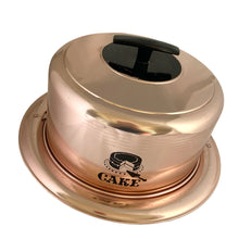 Load image into Gallery viewer, Vintage copper/rose gold toned aluminum dome cake carrier keeper featuring a black bakelite handle and an illustration in black of a sliced cake with the word "CAKE" below in a cute vintage font and locking levers to hold the dome securely to the base. The perfect vessel to store your home-baked or store bought confections! In as found vintage condition with wear to the black at the top of the dome, age-related wear. Fits up to a 10 1/2 x 5 inch cake Overall measures 14 1/2 x 8 inches