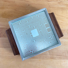 Load image into Gallery viewer, Vintage mid-century square Cosmopolitan Automatic Food Warmer with wood handles and a geometric surface. Salton, USA, 1960s. At any family dinner, my grandmother used her vintage Salton tray to keep all her yummy dishes hot. This one is perfectly sized for a coffee or tea pot and is small enough to be used on a desk or side table to keep your hot beverage warm.
In overall excellent vintage condition, no chips or cracks in the glass top. Good working order with cord.
Measures 8 1/4 x 6 1/4 inches