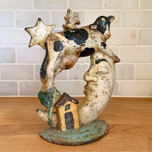 Load image into Gallery viewer, Rare early 20th century vintage The Cow Jumped Over the Moon nursery rhyme hand painted cast iron doorstop. Signed by the artist Arni on the base. This solid, one-piece diecast cut doorstop is an original free of mold seams, screws or grind marks and weighs 4 1/4 pounds. A wonderful piece of folk art to add charm to your home's decor.
In as found vintage condition with wear to the paint and rusty patina.
Measures 7 x 8 1/2 inches