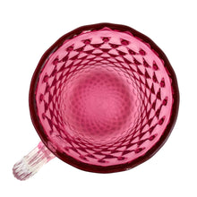 Load image into Gallery viewer, Stunning vintage hand blown cranberry optic glass mug, features a quilted diamond pattern with applied clear ribbed glass handle. Expertly crafted by Rossi Art Glass, Canada, circa 1980s. Perfect for way to elevate your hot beverage! In excellent condition, free from chips. Measures 3 1/2 x 4 3/4 inches
