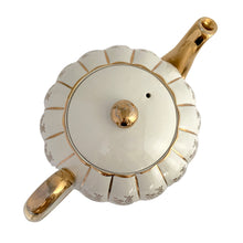Load image into Gallery viewer, Vintage W777 teapot, creamer and sugar set features vertically ribbed cream body, with cream ground and gold gilt flowers and details. Crafted by Gibsons, England, circa 1950s. Whether the star of your high tea service or for everyday use, you'll appreciate this beautifully decorated quality earthenware.
In excellent condition, no chips/cracks/repairs.