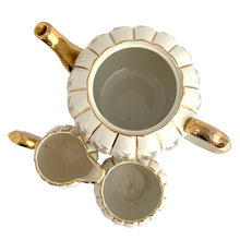 Load image into Gallery viewer, Vintage W777 teapot, creamer and sugar set features vertically ribbed cream body, with cream ground and gold gilt flowers and details. Crafted by Gibsons, England, circa 1950s. Whether the star of your high tea service or for everyday use, you'll appreciate this beautifully decorated quality earthenware.
In excellent condition, no chips/cracks/repairs.