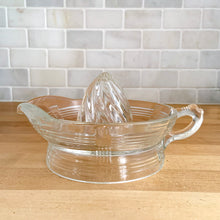 Load image into Gallery viewer, We are loving this vintage clear depression glass "Criss Cross" citrus juice reamer. Every home should have one of these practical kitchen helpers that makes squeezing oranges, lemons and limes a breeze! This one has a convenient spout and smooth finger handle design. Produced by Hazel-Atlas Glass, USA, circa 1930s. Perfect for the fresh squeezed juice enthusiast...no sugar added! In excellent condition, free from chips/wear. Measures 5 3/4 x 3 1/2 inches