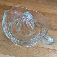 Load image into Gallery viewer, We are loving this vintage clear depression glass "Criss Cross" citrus juice reamer. Every home should have one of these practical kitchen helpers that makes squeezing oranges, lemons and limes a breeze! This one has a convenient spout and smooth finger handle design. Produced by Hazel-Atlas Glass, USA, circa 1930s. Perfect for the fresh squeezed juice enthusiast...no sugar added! In excellent condition, free from chips/wear. Measures 5 3/4 x 3 1/2 inches