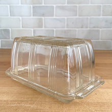 Load image into Gallery viewer, We are loving this vintage clear depression glass "Criss Cross" covered butter dish. Produced by Hazel-Atlas Glass, USA, circa 1930s. Perfect for the vintage kitchen enthusiast! In good vintage condition, lid is free from chips, interior rim of the dish flea bites. Measures 7 x 4 x 3 1/4 inches