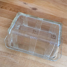 Load image into Gallery viewer, We are loving this vintage clear depression glass "Criss Cross" covered butter dish. Produced by Hazel-Atlas Glass, USA, circa 1930s. Perfect for the vintage kitchen enthusiast! In good vintage condition, lid is free from chips, interior rim of the dish flea bites. Measures 7 x 4 x 3 1/4 inches