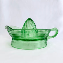 Load image into Gallery viewer, Hard to find vintage green uranium depression glass Criss Cross citrus reamer. Glows brilliantly under black light! Every home should have one of these practical kitchen helpers that makes squeezing citrus fruits a breeze! Crafted by Hazel-Atlas Glass, USA, 1930s. Perfect for the fresh squeezed juice enthusiast...no sugar added!
In excellent condition, no chips/wear.
Measures 5 3/4 x 3 1/2 inches