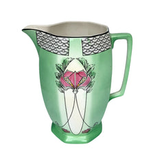 Load image into Gallery viewer, Elevated side view of art nouveau art deco Ford & Sons English ceramic green pitcher with elongated pink floral motif with black and white geometric scale motif at the rim