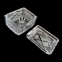 Load image into Gallery viewer, Elegant vintage cut crystal lidded cigarette box. Crafted by Bohemia Crystal, Czechoslovakia, 1970s. This box provides a decorative way to store cigarettes with the lid functioning as an ashtray. Not a smoker? Use this versatile elegant box to store playing cards, candies or trinkets. Add this statement piece to your home decor or give as a gift.
In excellent condition, no chips.
Measures 4 1/2 x 3 3/8 x 3 1/2 inches