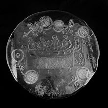 Load image into Gallery viewer, Vintage Dalom clear pressed glass platter with folded handles featuring a charming folk art inspired menagerie of seated figures at a table surrounded by whimsical flowers. Designed artisan Göran Wärff. Crafted by Kosta Boda, Sweden, 1970s. An artful serving tray for charcuterie, desserts or just about anything. One could use this as a centrepiece with pillar candles...the possibilities are endless for this conversation piece!
In excellent condition, no chips.
Measures 14 inches in diameter