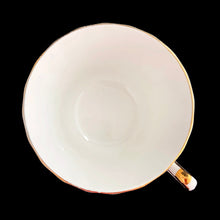 Load image into Gallery viewer, Vintage fine bone china teacup and saucer featuring dark pink roses, pale blue baby's breath and gold gilt trim on a swirl shape. Crafted by Delphine, England, 1930 - 1941. A lovely way to enjoy a cuppa tea!
In excellent condition, no chips, cracks or repairs. Maker's mark on the bottom.
Measures 3 3/8 x 2 1/2 inches | Saucer measures 5 3/4 inches