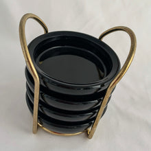 Load image into Gallery viewer, A vintage set of deep red, almost black pressed glass coasters in brass metal caddy. So handy for entertaining or everyday use! These sets were typically sold at high-end retailers like Birks Canada. In excellent condition, the glass is free from chips/cracks. Each coaster measures 3 3/4 x
