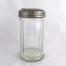 Load image into Gallery viewer, Bring the nostalgia of classic restaurant diners to your table with this vintage pressed glass sugar dispenser, featuring clear vertical panels and a chrome lid. Crafted by Halco USA. Add a timeless touch to your kitchen coffee/tea station! In excellent condition, free from chips with only minor wear on the lid. Measure 3 x 5 3/4 inches