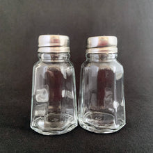 Load image into Gallery viewer, Sail away to flavor-town with this retro vintage set of salt and pepper shakers! These 50s-style shakers come with stylish clear pressed glass panels and stainless steel screw-on lids. Season your food with a real blast from the past! The glass is in excellent condition, free from chips/cracks. The lids have very minor wear, see photos. Marked "MEXICO". Measures 1 3/8 x 3 inches