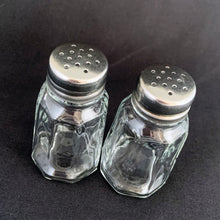 Load image into Gallery viewer, Sail away to flavor-town with this retro vintage set of salt and pepper shakers! These 50s-style shakers come with stylish clear pressed glass panels and stainless steel screw-on lids. Season your food with a real blast from the past! The glass is in excellent condition, free from chips/cracks. The lids have very minor wear, see photos. Marked "MEXICO". Measures 1 3/8 x 3 inches
