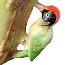 Load image into Gallery viewer, Close-up of sculpted woodpecker handle on vintage Czech Majolica pitcher — red crown, black mask, cream and green body, clinging to tree-form