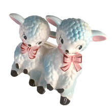 Load image into Gallery viewer, Adorable and rare, anthropomorphic hand painted pale blue double lamb planter with each lamb wearing a pink bow. Crafted by ARCO, Japan, 1950s. A sweet kitschy addition for your new addition. Use for tiny plants or repurpose to hold baby accessories.
In excellent as found vintage condition, no chips/cracks/repairs, normal crazing present.
Measures 5 1/2 x 4 3/4 x 6 inches