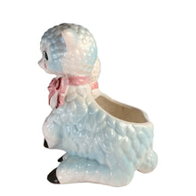Load image into Gallery viewer, Adorable and rare, anthropomorphic hand painted pale blue double lamb planter with each lamb wearing a pink bow. Crafted by ARCO, Japan, 1950s. A sweet kitschy addition for your new addition. Use for tiny plants or repurpose to hold baby accessories.
In excellent as found vintage condition, no chips/cracks/repairs, normal crazing present.
Measures 5 1/2 x 4 3/4 x 6 inches