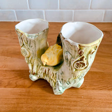 Load image into Gallery viewer, Once can't help but smile at this adorable pale green double tree trunk vase with sweet yellow bird perched in the middle and gold gilt details. This vessel is perfect for creating a small floral bouquet or simply display it amongst your treasures. Produced by Ucagco, Japan, circa 1950s. In excellent condition, free from chips/cracks/repairs. Marked Japan on the bottom. Measures 5 1/8 x 3 x 4 1/4 inches