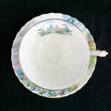 Load image into Gallery viewer, This vintage bone china footed teacup and saucer is so sweet! Both the cup and saucer are decorate with the "Dovedale" pattern from the Country Scenes series. Each piece has a lovely scalloped edge with hand painted whimsical country scene, trimmed with gold gilt. Produced by Royal Albert, England, circa 1917 - 1927. In excellent condition, free from chips, cracks and repairs. Maker's marks are on the bottom. Teacup measures 3 3/8 x 2 3/4 inches | Saucer measures 5 1/2 inches