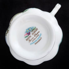 Load image into Gallery viewer, This vintage bone china footed teacup and saucer is so sweet! Both the cup and saucer are decorate with the "Dovedale" pattern from the Country Scenes series. Each piece has a lovely scalloped edge with hand painted whimsical country scene, trimmed with gold gilt. Produced by Royal Albert, England, circa 1917 - 1927. In excellent condition, free from chips, cracks and repairs. Maker's marks are on the bottom. Teacup measures 3 3/8 x 2 3/4 inches | Saucer measures 5 1/2 inches