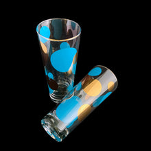 Load image into Gallery viewer, RARE FIND!
Vintage mid century era Eclipse cooler glass featuring blue and 22 karat gold dots in varying size with gold rims. Designed by Russel Wright, American industrial designer, for Bartlett Collins, 1958. A must-have for the serious MCM barware collector...cheers!
In great vintage condition, no chips, very minor age related wear to the gold.
Measures 2 7/8 x 6 7/8 inches
Capacity 16 ounces