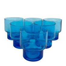 Load image into Gallery viewer, Set of 6 vintage Italian electric blue stackable glasses, three-quarter overhead view showing all six arranged in a pyramid formation with rounded bodies and thick cobalt blue bases