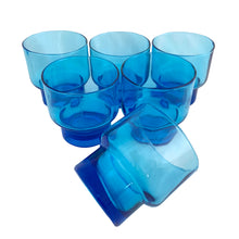 Load image into Gallery viewer, Set of 6 vintage Italian electric blue stackable glasses, three-quarter view with five glasses upright and one tipped on its side showing the thick cobalt blue base and stackable foot detail