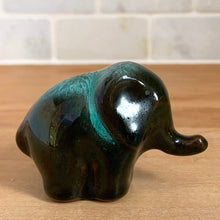 Load image into Gallery viewer, Blue Mountain Pottery elephant figurine, side profile view — full body silhouette showing green drip glaze, raised trunk, tail detail
