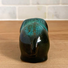 Load image into Gallery viewer, Blue Mountain Pottery elephant figurine, rear view — "African Lion Safari" gold script inscription clearly visible across the back, green drip glaze