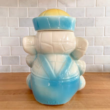 Load image into Gallery viewer, Vintage mid-century hand painted figural white elephant ceramic cookie jar with blue and yellow sailor hat and overalls and pink details. Crafted by American Bisque, USA, circa 1950s. Add some kitsch to your kitchen decor with this adorable collectible!
In excellent condition, no chips or cracks, age-related crazing. Marked USA on the back of the jar.
Measures 8 1/2 x 6 x 10 1/2 inches