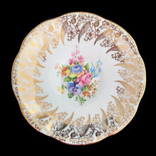 Load image into Gallery viewer, Vintage Elizabethan fine bone china Clare teacup and saucer with colourful roses and gold gilt filigree and trim. Crafted by Taylor & Kent, England, 1980s. A lovely way to enjoy a cuppa tea!
In excellent condition, no chips, cracks or repairs. Maker's mark on the bottom.
Measures 3 3/8 x 2 1/2 inches | Saucer measures 5 5/8 inches