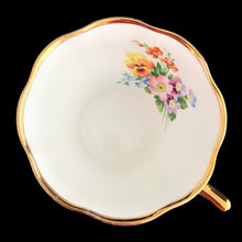 Load image into Gallery viewer, Vintage Elizabethan fine bone china Clare teacup and saucer with colourful roses and gold gilt filigree and trim. Crafted by Taylor & Kent, England, 1980s. A lovely way to enjoy a cuppa tea!
In excellent condition, no chips, cracks or repairs. Maker's mark on the bottom.
Measures 3 3/8 x 2 1/2 inches | Saucer measures 5 5/8 inches