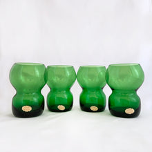 Load image into Gallery viewer, Funky set of four vintage emerald green hand blown glass tumblers. Crafted in Poland, circa 1960s. These glasses feature a bloated hourglass shape. Guaranteed to amp up your bar cart! In excellent condition, free from chips/wear. Original sticker present on each glass, marked "Made in Poland". Measures 2 3/8 x 3 3/8 inches Capacity 6 ounces